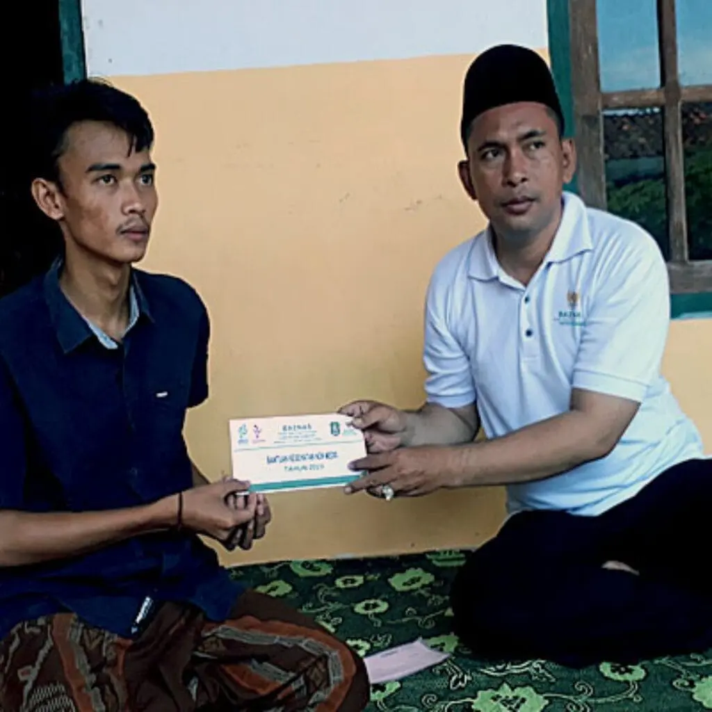 Ketua Baznas Kabupaten Sumenep, M. Sukri saat menyerahkan bantuan