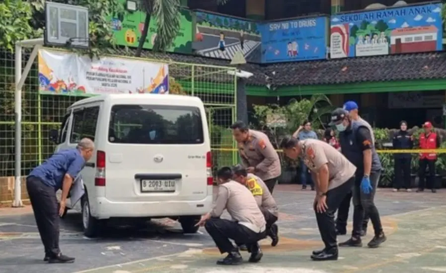 Petugas memeriksa lokasi kecelakaan mobil pengantar MBG yang menerobos halaman SDN Kalibaru 01 Cilincing.